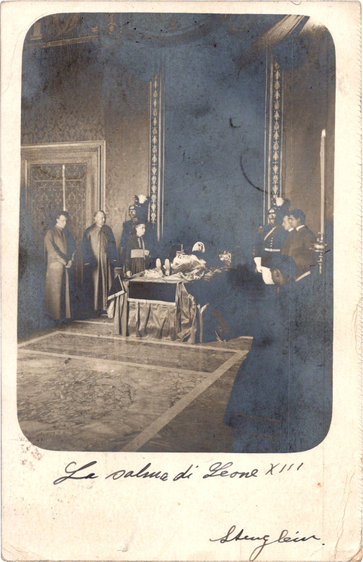 a group of people standing around a body lying in state