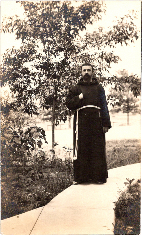 a franciscan monk standing outside