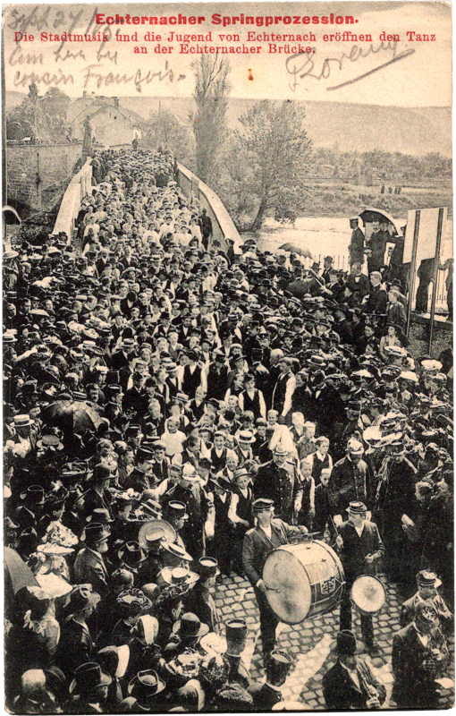 a large crowd of people walking on a bridge