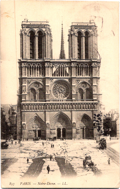 a large building with towers and people walking around