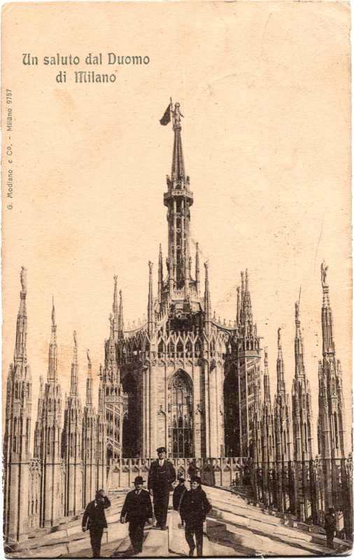 a large building with spires and a flag on top