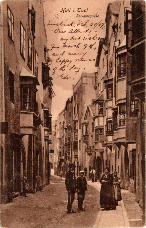 a group of people walking down a narrow street
