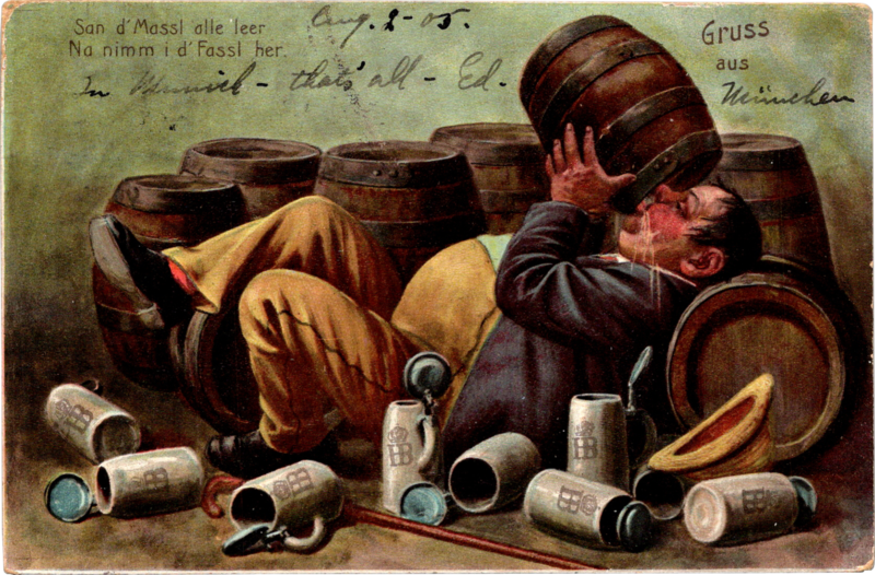 a person lying on the ground with a barrel of beer