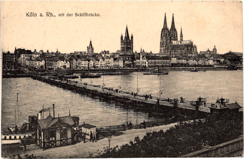 a bridge over water with a city in the background
