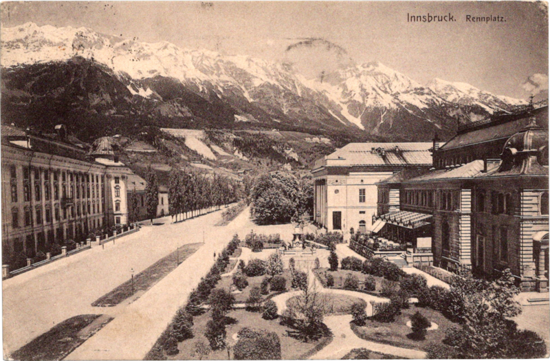 a black and white photo of a street with buildings and trees