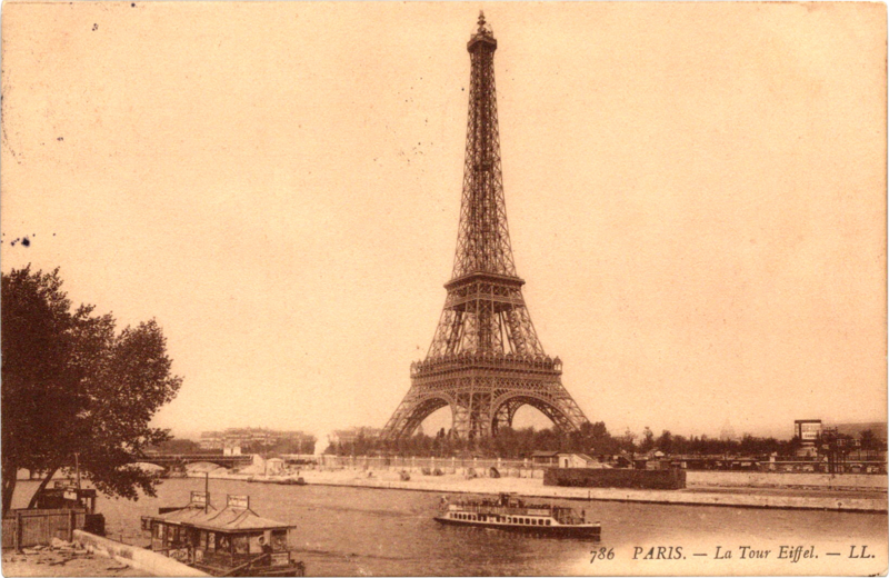 a boat in the water with Eiffel Tower in the background