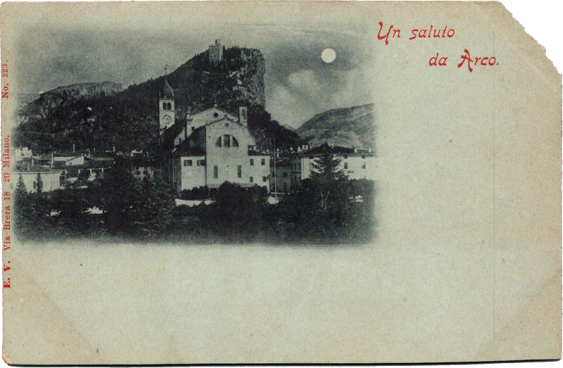 a building with a steeple and a mountain in the background