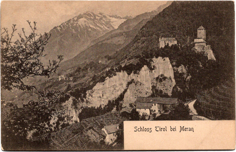 a mountain landscape with buildings and snow capped mountains