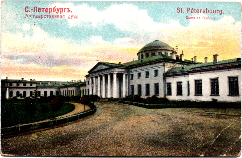 a large white building with columns and a circular roof
