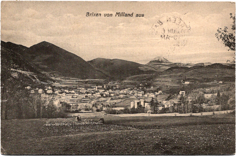 a black and white photo of a town in a valley