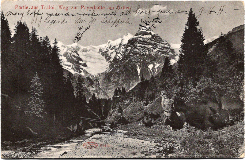 a river running through a valley with trees and mountains