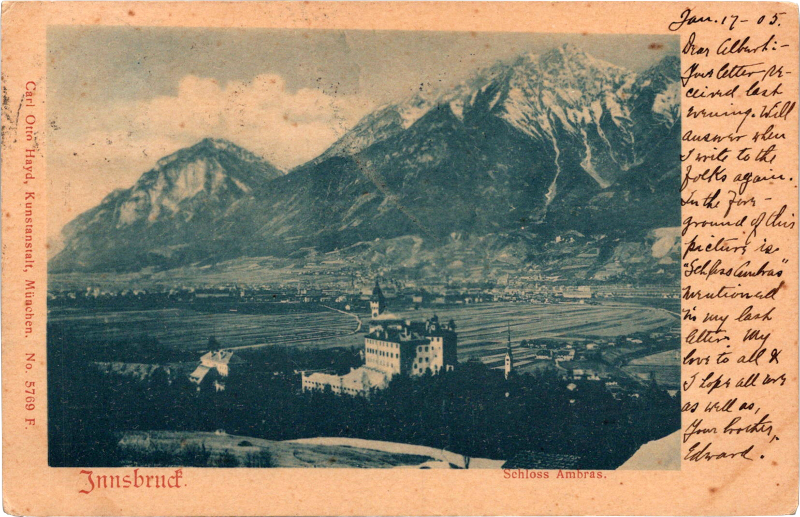 a black and white photo of a town with a mountain in the background