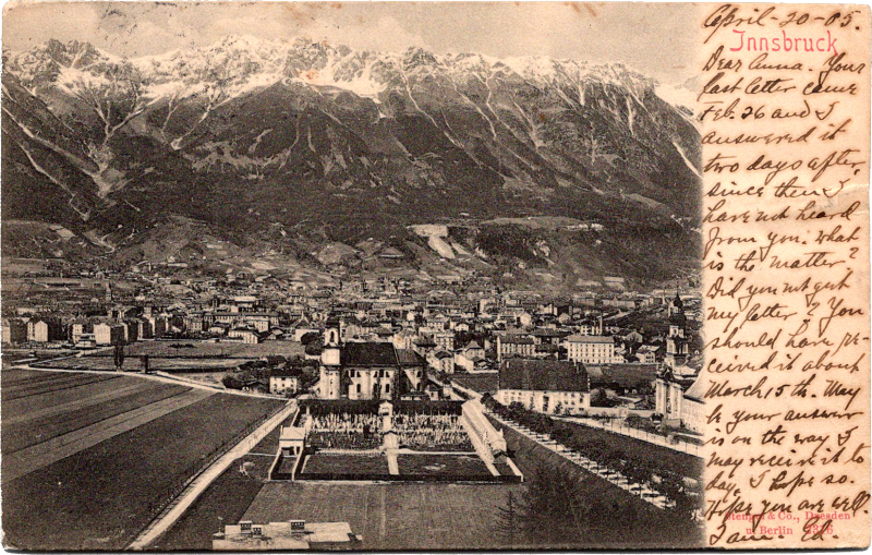 a black and white photo of a city with a mountain in the background