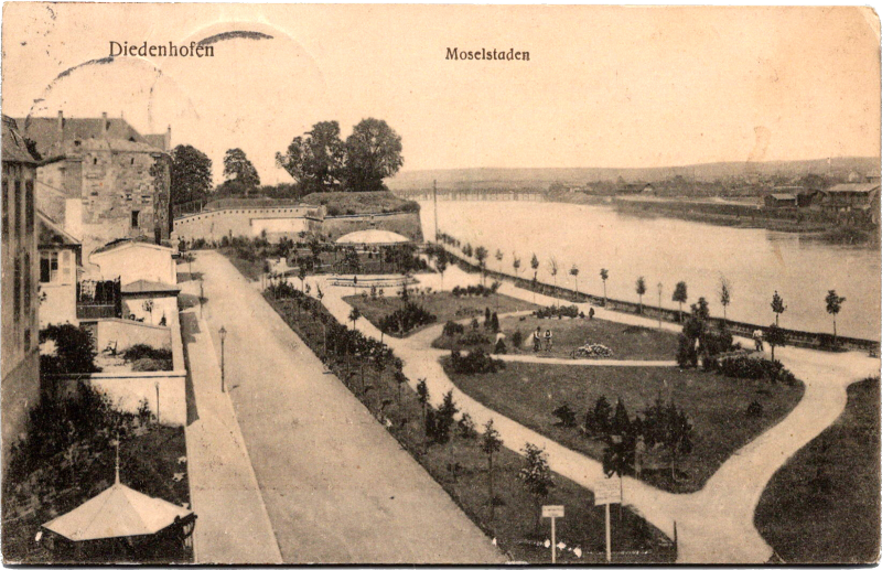 a black and white photo of a park next to a river