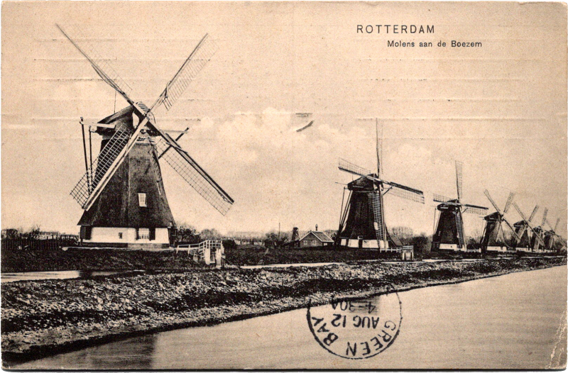 a group of windmills by a river