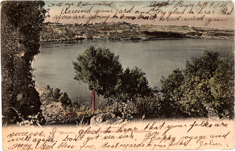 a body of water with trees and a rocky hill