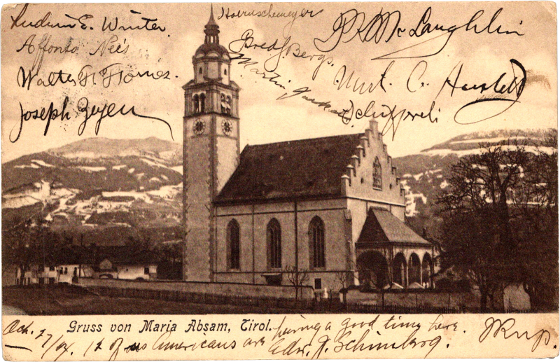 a church with a tower and a mountain in the background