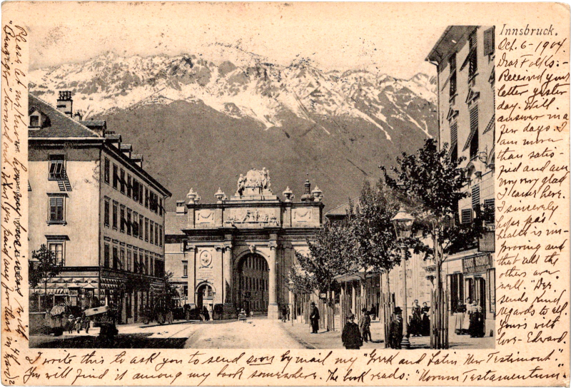 a street with buildings and a snowy mountain in the background