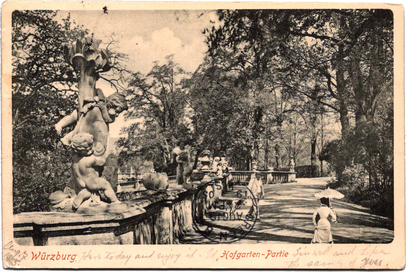 An old photo of a statue in a park.
