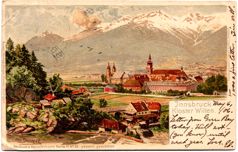 A postcard with a view of a village and mountains.