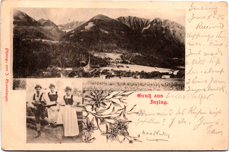 A postcard with a picture of people and a mountain.